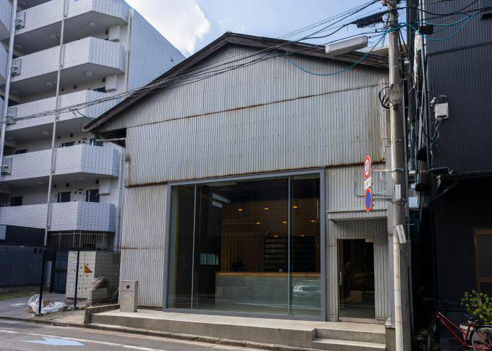 The industrial exterior of Koffee Mameya Kakeru, an omakase course menu coffee spot in Tokyo.